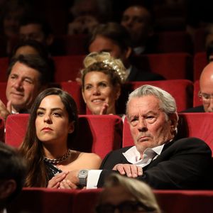 Alain Delon (avec un badge Paris Match d'une ancienne couverture du magazine titrant "Alain Delon, mes deux amours, Rosalie et Anouchka) et sa fille Anouchka - Remise de la Palme d'Honneur à Alain Delon lors du 72ème Festival International du Film de Cannes. 19 mai 2019. © Jacovides-Moreau / Bestimage