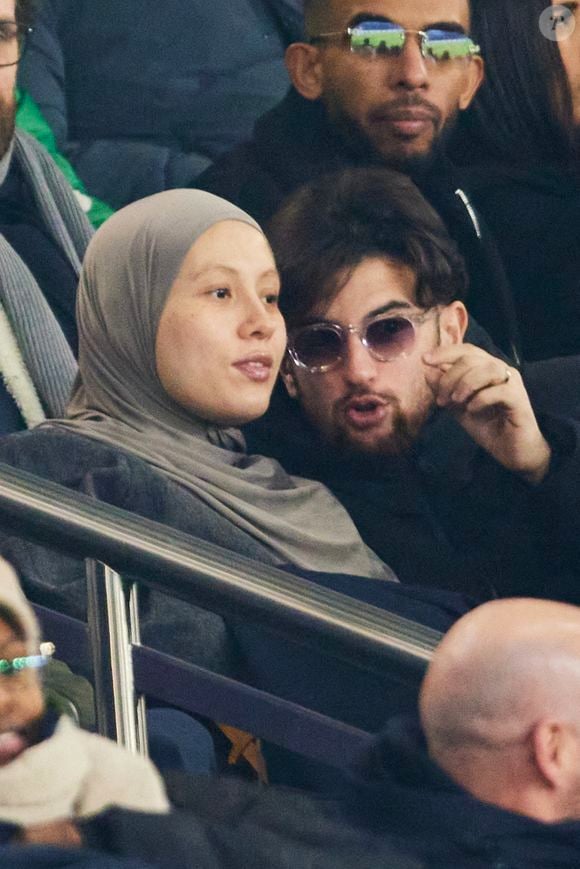 Just Riadh et sa femme dans les tribunes lors du match de Ligue Des Champions 2024-2025 (LDC) "PSG - Brest (7-0)" au Parc Des Princes, le 19 février 2025.
© Cyril Moreau/Bestimage