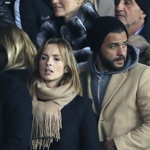 Maxim Nucci et sa compagne Isabelle Ithurburu enceinte assistent au huitième de finale retour de Ligue des Champion, du Paris Saint-Germain contre le Real Madrid au Parc des Princes à Paris le 6 mars 2018. © Cyril Moreau/Bestimage