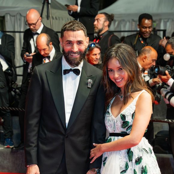 Le couple affiche un large sourire et l’ambiance a l’air particulièrement bonne et décontractée

Karim Benzema et sa compagne Lyna Khoudri à la descente des marches du film « 13 jours 13 nuits » lors du 78ème Festival International du Film de Cannes. Le 23 mai 2025
© Backgrid USA/ Bestimage