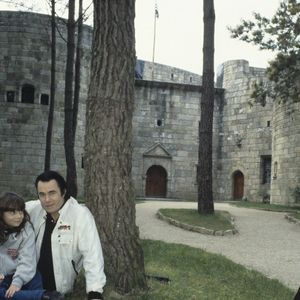 Pour ancrer son succès dans le sol breton, l'auteur-compositeur a imaginé et fait construire une imposante bâtisse en granit.

Archives - En France, chez lui, à Stirwen en Bretagne,  Alain Barrière avec sa femme Anièce et sa fille Guénaëlle le 8 avril 1984.

© Bestimage