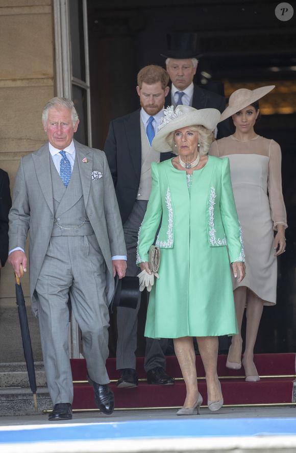 Le prince Charles devient Charles III, roi du Royaume-Uni - Camilla Parker Bowles, duchesse de Cornouailles, le prince Harry, duc de Sussex, et Meghan Markle, duchesse de Sussex, lors de la garden party pour les 70 ans du prince Charles au palais de Buckingham à Londres. Le 22 mai 2018 (Agence / Bestimage).