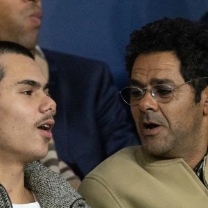 Jamel Debbouze et son fils Léon - Célébrités dans les tribunes du match de Ligue des Champions entre le PSG contre le Bayern de Munich (1-2) au Parc des Princes à Paris le 4 novembre 2025. © Cyril Moreau/Bestimage