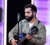 "Mais je reviens mon amour, je vais faire des concerts et après je reviens", lui a répondu l'artiste

Kendji Girac, chanteur et guitariste français lors du Téléthon 2023, à Saint Denis, près de Paris, France le 9 décembre 2023. Photo par Alexis Jumeau/ABACAPRESS.COM