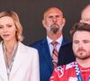Pour la cérémonie sur le podium, Charlene de Monaco portait un tailleur blanc élégant assorti d’escarpins.

Le prince Albert II et la princesse Charlène de Monaco sur le podium lors de la remise de prix du E-Prix de Monaco du Championnat du monde FIA de Formule E 2026 sur le circuit de Monaco à Monte-Carlo, Monaco, le 17 mai 2026. Le pilote britannique Oliver Rowland remporte la deuxième course du week-end à Monaco devant le Brésilien Felipe Drugovich et le Portugais Antonio Félix Da Costa. © Claudia Albuquerque/Bestimage