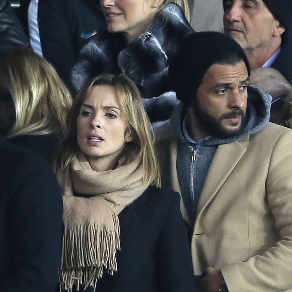 Maxim Nucci et sa compagne Isabelle Ithurburu enceinte assistent au huitième de finale retour de Ligue des Champion, du Paris Saint-Germain contre le Real Madrid au Parc des Princes à Paris le 6 mars 2018. © Cyril Moreau/Bestimage