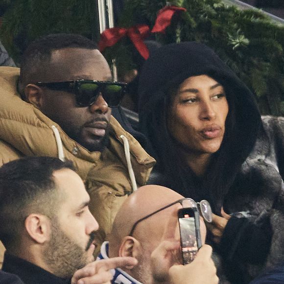 Gims et sa femme DemDem dans les tribunes du match de Ligue 1 McDonald's opposant le Paris Saint-Germain (PSG) à Lyon (3-1) au Parc des Princes à Paris le 15 décembre 2024.