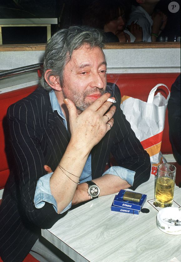 Le chanteur français Serge Gainsbourg fumant et buvant du whisky dans un pub près de Montparnasse à Paris, France, en septembre 1987. Photo par Christophe Geyres/ABACAPRESS.COM