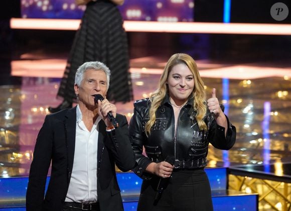 "Je trouvais ça joli de reverser une partie des bénéfices de ma tournée. Les gens qui sont venus me voir en concert ont aussi œuvré, sans le savoir, pour le Téléthon. J’ai la chance de pouvoir le faire. Et je me souhaite de pouvoir réitérer ce don chaque année."

Santa (marraine de l'édition 2025), Nagui lors de la deuxième soirée de la 39ème édition du Téléthon sur France 2 aux Studios du Lendit à Saint-Denis, France, le 6 décembre 2025. Les trente heures du Téléthon 2025 s'achèvent sur un compteur de 83,5 millions d'euros. © Anne-Sophie Guebey/Bestimage