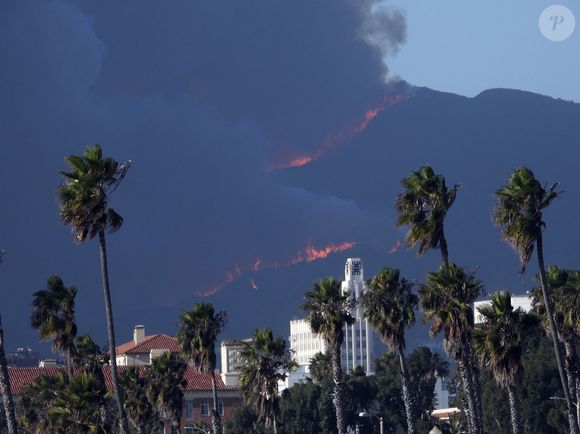 Los Angeles, CA - Le feu fait rage dans les maisons de plusieurs millions de dollars du quartier de Pacific Palisades à Los Angeles. Voici la vue du brasier depuis Venice Beach. On peut voir des avions déverser des extincteurs sur les flammes. La fumée recouvre complètement la ligne d'horizon. Parmi les célébrités qui possèdent une maison dans le quartier de Palisades, on trouve Tom Hanks, Adam Sandler, Larry David, Steven Spielberg, Matt Damon, Ben Affleck et Arnold Schwarzenegger.