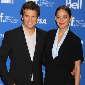 Naissance - Marion Cotillard a donné naissance à une petite fille le 10 mars - Guillaume Canet et Marion Cotillard (habillee en Dior Haute Couture) - Photocall du film "Blood Ties" au festival du Film de Toronto le 10 septembre 2013