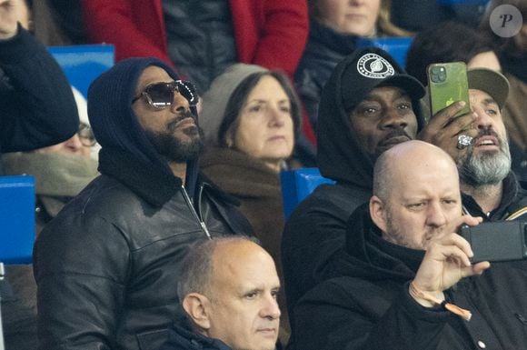 Stomy Bugsy et Passi - Célébrités dans les tribunes lors du match de Ligue des Champions entre le Paris Saint Germain contre Tottenham Hotspur Football Club (5-3) au Parc des Princes à Paris le 26 novembre 2025. © Cyril Moreau/Bestimage