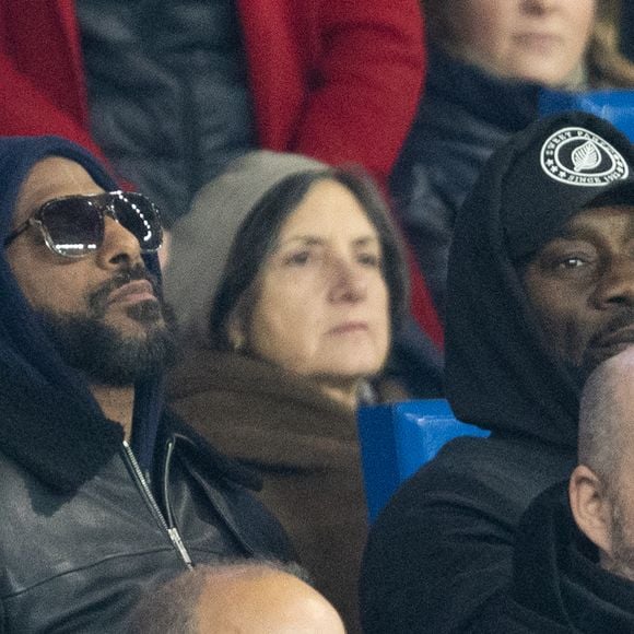 Stomy Bugsy et Passi - Célébrités dans les tribunes lors du match de Ligue des Champions entre le Paris Saint Germain contre Tottenham Hotspur Football Club (5-3) au Parc des Princes à Paris le 26 novembre 2025. © Cyril Moreau/Bestimage