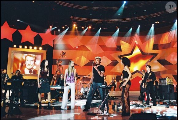 Johnny Hallyday en compagnie de Nolwenn Leroy, Emma Daumas et Aurélie à la "Star Academy" en 2002.