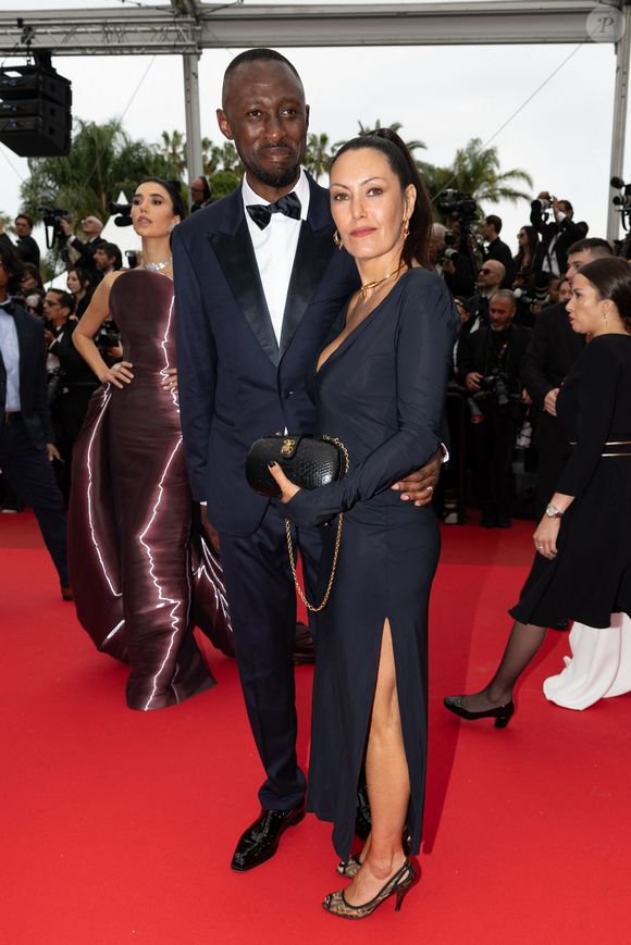 Thomas Ngijol et sa femme Karole Rocher - Montée des marches du film « Highest 2 Lowest  » lors du 78ème Festival International du Film de Cannes, au Palais des Festivals à Cannes. Le 19 mai 2025
© Olivier Borde/ Bestimage