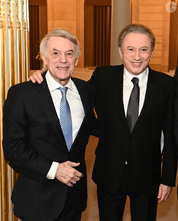 Exclusif - Prix Spécial - No web -   Michel Drucker, et Salvatore Adamo   . M.Drucker reçoit la médaille de Commandeur de la Légion d’honneur par le président de la République Française Emmanuel Macron au palais de l'Elysée à Paris, le 13 février 2025.
© Guillaume Gaffiot / Bestimage