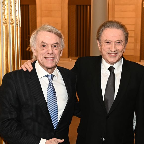 Exclusif - Prix Spécial - No web -   Michel Drucker, et Salvatore Adamo   . M.Drucker reçoit la médaille de Commandeur de la Légion d’honneur par le président de la République Française Emmanuel Macron au palais de l'Elysée à Paris, le 13 février 2025.
© Guillaume Gaffiot / Bestimage