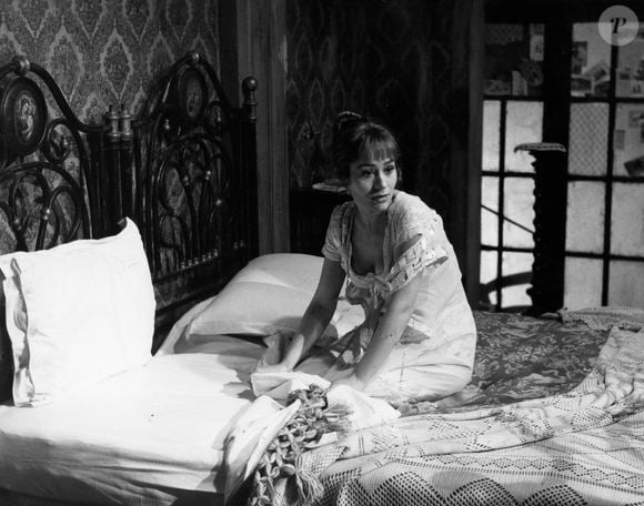 8 mai 1960 - Lieu inconnu - ANNIE GIRARDOT, née le 25 octobre 1931, est une actrice qui a fait ses débuts dans le film "Treize a table". Elle a remporté de nombreux prix tout au long de sa carrière pour ses talents. PHOTO : Annie Girardot assise sur un lit dans une scène de film.    (Crédit image : ? Keystone Press Agency/ZUMA Press Wire)