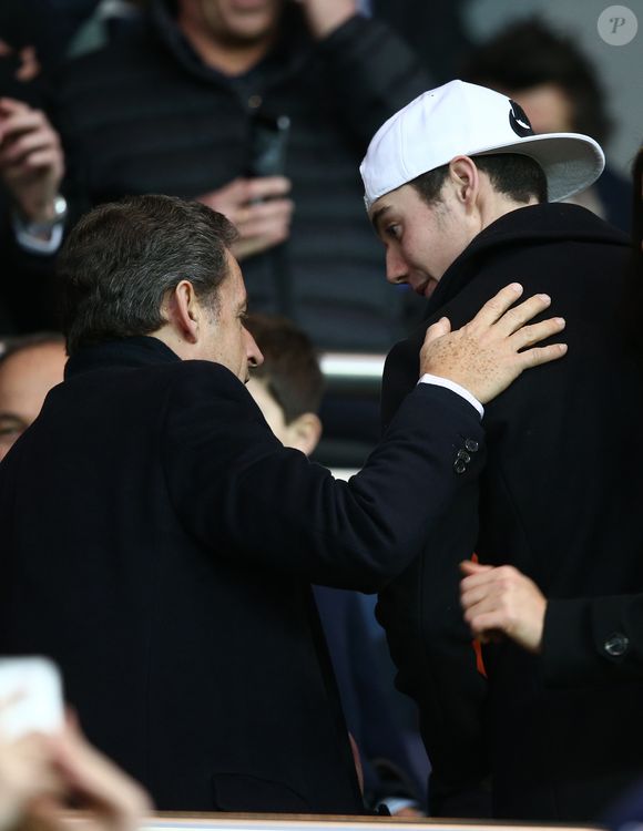 à cinq ans de prison pour "association de malfaiteurs". 

Nicolas Sarkozy et son fils Louis Sarkozy - People au match PSG-Montpellier 19ème journée au Parc des Princes, le 20 décembre 2014.