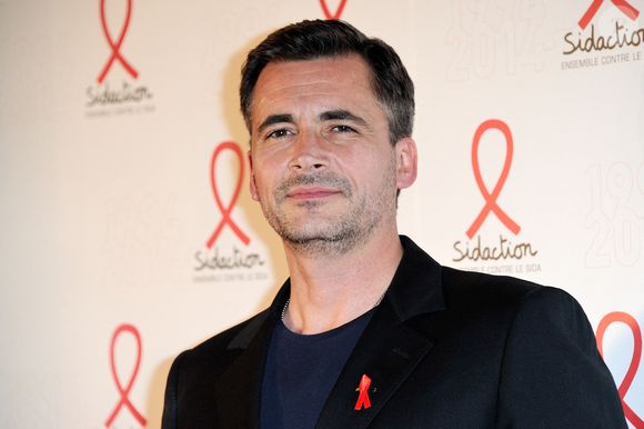 Olivier Minne posant lors d'un photocall pour le lancement du Sidaction 2014 et du 'Sidaction 20e anniversaire' qui s'est tenu au Musée du quai Branly à Paris, France, le 10 mars 2014. Photo par Aurore Marechal/ABACAPRESS.COM