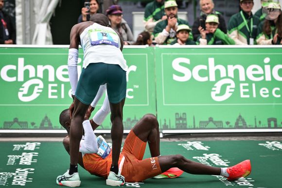 Les coureurs s'entraident en franchissant la ligne d'arrivée du Marathon de Paris 2025 à Paris le 13 avril 2025. Photo by Firas Abdullah/ABACAPRESS.COM