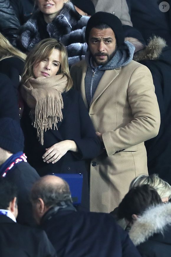 Maxim Nucci et sa compagne Isabelle Ithurburu enceinte assistent au huitième de finale retour de Ligue des Champion, du Paris Saint-Germain contre le Real Madrid au Parc des Princes à Paris le 6 mars 2018. © Cyril Moreau/Bestimage