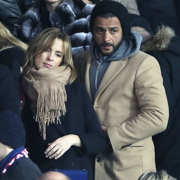 Maxim Nucci et sa compagne Isabelle Ithurburu enceinte assistent au huitième de finale retour de Ligue des Champion, du Paris Saint-Germain contre le Real Madrid au Parc des Princes à Paris le 6 mars 2018. © Cyril Moreau/Bestimage