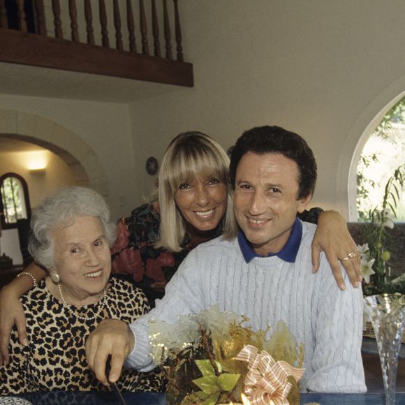Archives - En France, dans sa maison de vacances en Provence, Michel DRUCKER, sa mère Lola et sa femme Dany SAVAL, devant le gâteau d'anniversaire pour les 50 ans de Michel DRUCKER. Septembre 1992
© Alain Canu via Bestimage