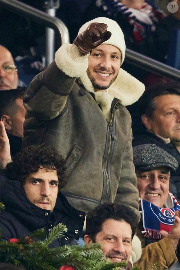 Louis Garrel, Vianney et son père dans les tribunes du match de Ligue 1 McDonald's opposant le Paris Saint-Germain (PSG) à Lyon (3-1) au Parc des Princes à Paris le 15 décembre 2024.