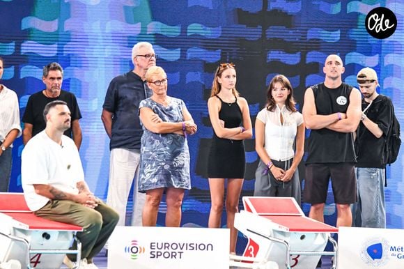 Manon Bousquet (fille de L.Manaudou et F.Bousquet) - Jean-Luc Manaudou, sa femme Olga, Elsa Bois, Nicolas Manaudou - Hommage à Florent Manaudou lors des Championnats d'Europe de natation au centre aquatique olympique à Saint-Denis le 15 août 2026

© Baptiste Autissier / PsnewZ / Bestimage
