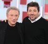 Pour célébrer ses soixante ans de télévision, le pilier du PAF signe un nouveau livre de souvenirs riche en confidences et en hommages. 

Exclusif - Michel Drucker et Patrick Bruel lors de l'enregistrement de l'émission "Vivement dimanche" au studio Rive Gauche, présentée par M.Drucker avec une diffusion sur France 3, à Paris, France. © Guillaume Gaffiot/Bestimage