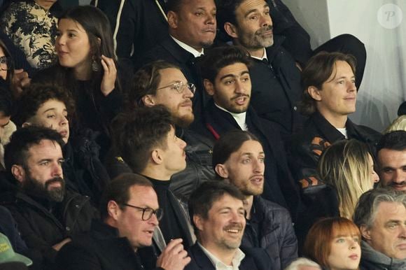 Pierre Sarkozy et Jean Sarkozy - Célébrités dans les tribunes du match de Ligue 1 Uber Eats "PSG-Lyon" (4-1) au Parc des Princes à Paris le 21 avril 2024. © Cyril Moreau/Bestimage