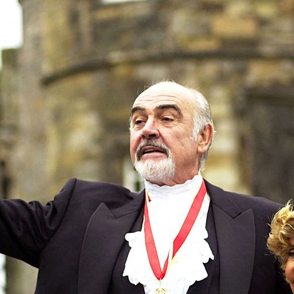 Photo d'archives du 05/07/00 de l'acteur Sir Sean Connery, avec son épouse Micheline, portant sa médaille après avoir été officiellement fait chevalier par la Reine lors d'une cérémonie d'investiture, au Palais de Holyroodhouse à Edimbourg. © David Cheskin/PA Wire. ABACA