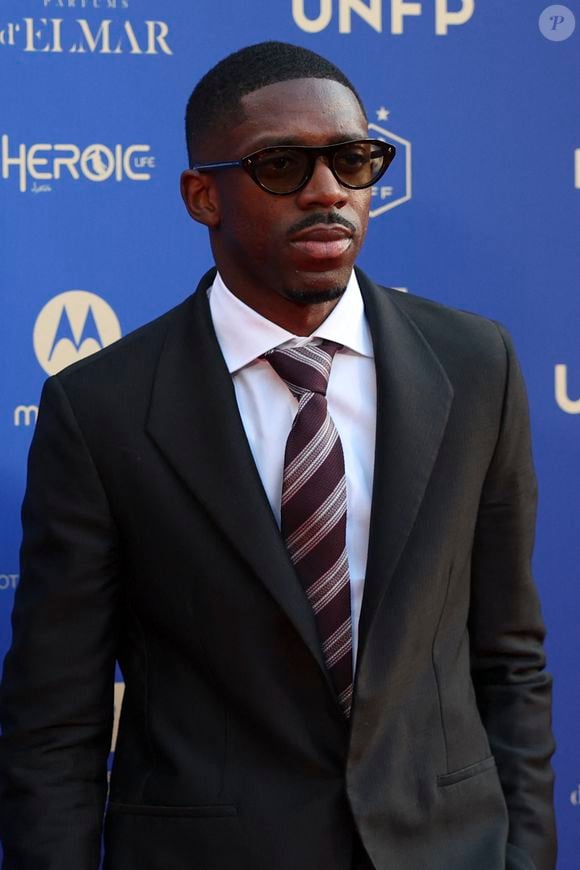 En marge de ces grands rendez-vous sportifs, le joueur diversifie ses activités en devenant ambassadeur d'une marque de luxe.

Ousmane Dembélé - Photocall de la 34ème édition des Trophées UNFP du Football au Palais Brongniart à Paris le 11 mai 2026. © Michael Baucher/PsnewZ/Bestimage