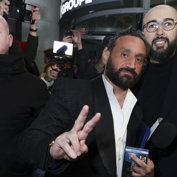 Exclusif - Cyril Hanouna se fait remettre son bagde de collaborateur du Groupe M6 par un des responsables de la sécurité - Les chroniqueurs et les invités quittent la dernière émission "Touche pas à mon poste" (TPMP) en bus pour se rendre devant le siège du groupe M6 à Neuilly-sur-Seine le 27 février 2025. © Jack Tribeca/Bestimage