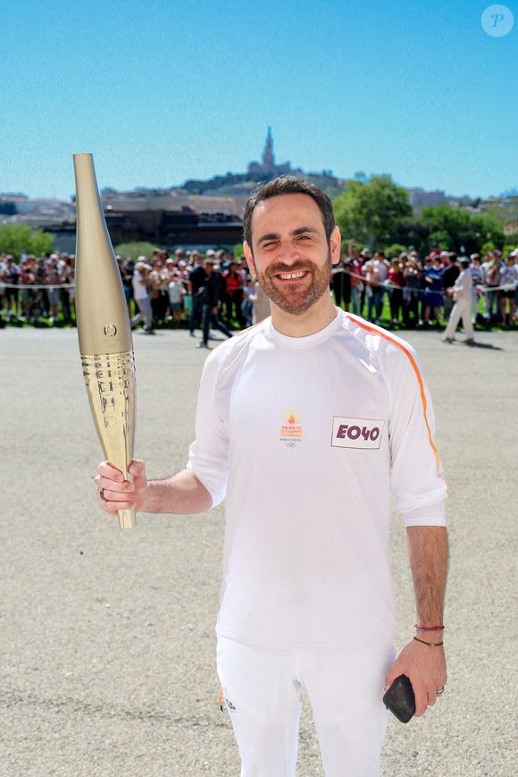 Camille Combal avec la torche lors de la première étape du relais de la flamme olympique à Marseille, France, le 9 mai 2024. Les porteurs de la torche doivent transporter la flamme olympique dans les rues de la cité phocéenne de Marseille, un jour après son arrivée sur le majestueux navire à trois mâts "Belem" pour la cérémonie d'accueil. Le relais de la torche olympique parcourra 12 000 kilomètres (7500 milles) à travers la France. © Dominique Jacovides/Bestimage