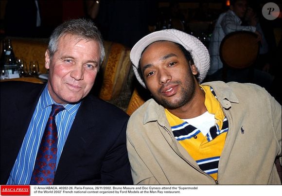© Arno/ABACA. 40262-26. Paris-France, 26/11/2002. Bruno Masure et Doc Gyneco assistent au concours national français "Supermodel of the World 2002" organisé par Ford Models au restaurant Man Ray.