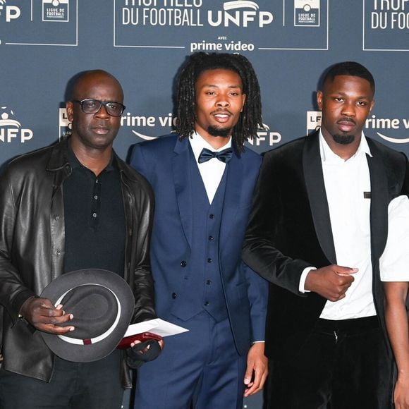 Lilian Thuram avec ses fils Khephren Thuram, Marcus Thuram, guest - Photocall de la cérémonie des Trophées UNFP au Pavillon Gabriel à Paris. © Coadic Guirec/Bestimage