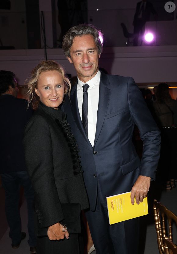 Exclusif - Caroline Roux et son mari Laurent Solly - Le professeur S.Lyonnet, président de l'Institut des maladies génétiques, et le galériste K. Mennour ont organisé la 4ème édition de la soirée "Heroes for Imagine", une grande vente aux enchères d’oeuvres d'art, animée par G.Elmaleh et dirigée par Christie's, à l'institut Imagine, 24 boulevard du Montparnasse dans le 15ème arrondissement de Paris, France, le 12 septembre 2022. © Dominique Jacovides/Bestimage