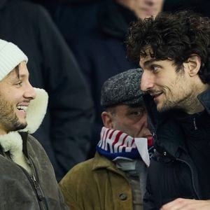 Vianney et Louis Garrel dans les tribunes du match de Ligue 1 McDonald's opposant le Paris Saint-Germain (PSG) à Lyon (3-1) au Parc des Princes à Paris le 15 décembre 2024.