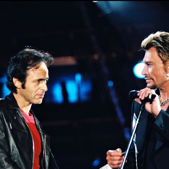 ARCHIVES - JEAN JACQUES GOLDMAN ET JOHNNY HALLYDAY SUR SCENE LORS D' UN CONCERT AU STADE DE FRANCE
