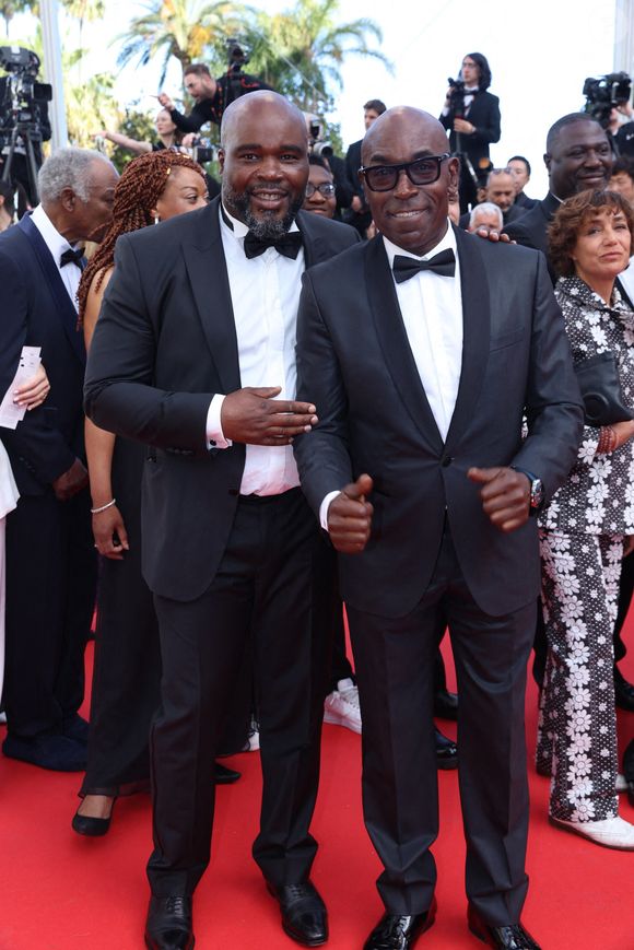 Guest et Lucien Jean-Baptiste assistent au tapis rouge de "La Venue De L'avenir" (Colours Of Time) lors de la 78ème édition du Festival de Cannes au Palais des Festivals le 22 mai 2025 à Cannes, France. Photo by Jerome Domine/ABACAPRESS.COM