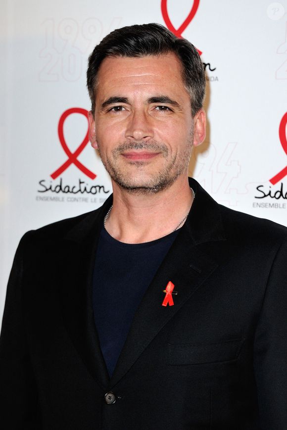 Olivier Minne posant lors d'un photocall pour le lancement du Sidaction 2014 et du 'Sidaction 20e anniversaire' qui s'est tenu au Musée du quai Branly à Paris, France, le 10 mars 2014. Photo par Aurore Marechal/Abaca
