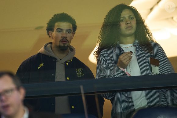 Warren Zaïre-Emery et Océane Nathalie Toussaint Dit Marseille dans les tribunes lors du match de Ligue Des Champions 2024-2025 (LDC) "PSG - Brest (7-0)" au Parc Des Princes, le 19 février 2025.
© Cyril Moreau/Bestimage