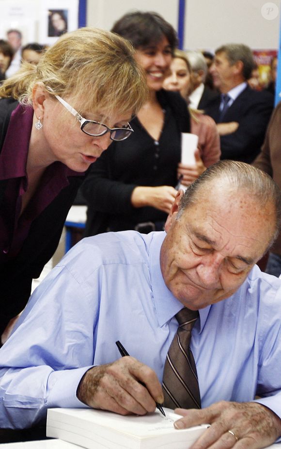 L'ancien président français Jacques Chirac, accompagné de sa fille Claude Chirac, signe des exemplaires de son livre à la foire du livre de Brive-la-Gaillarde, dans le sud de la France, le 7 novembre 2009.  Photo par Patrick Bernard/ABACAPRESS.COM