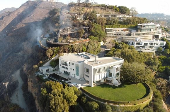 Une demeure qui possède "un pavillon en pierre calcaire à deux niveaux, une piscine et une terrasse à flanc de falaise, ainsi qu’un terrain de motoculture bordé d’arbres". 

Exclusif - La maison de Tom Hanks a été épargnée par l'incendie de Pacific Palisades alors que ses proches voisins n'ont pas eu la même chance ! le 9 janvier 2025.
