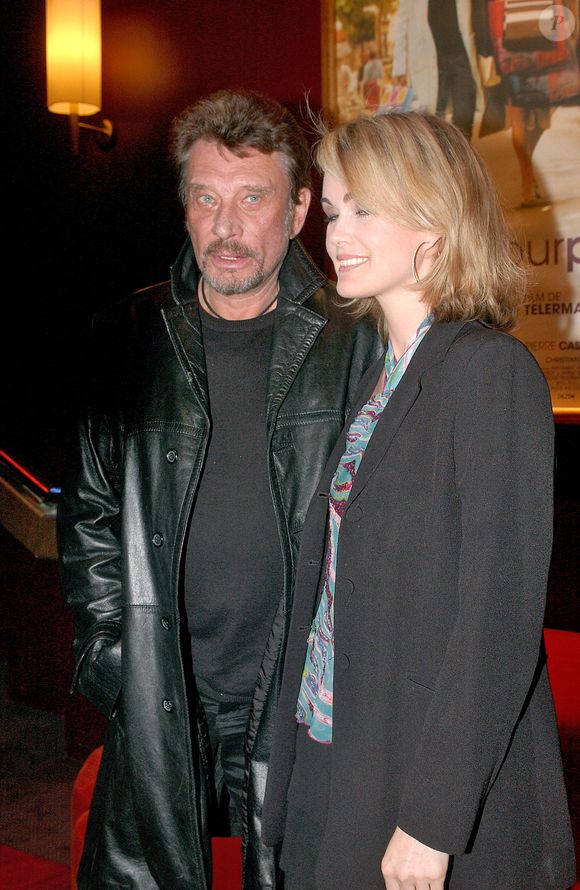 Le chanteur français Johnny Hallyday et son épouse Laeticia assistent à la première de 'Tout Pour Plaire' au Gaumont Marignan sur les Champs Elysées à Paris, France, le 8 mars 2005. Photo par Giancarlo Gorassini/ABACA.
