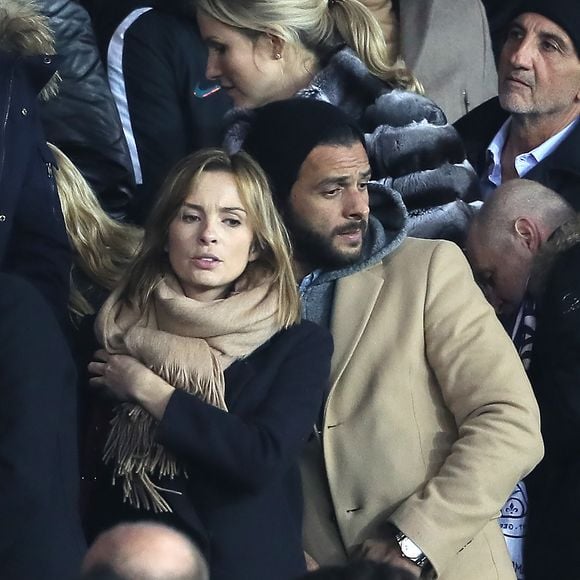 Maxim Nucci et sa compagne Isabelle Ithurburu enceinte assistent au huitième de finale retour de Ligue des Champion, du Paris Saint-Germain contre le Real Madrid au Parc des Princes à Paris le 6 mars 2018. © Cyril Moreau/Bestimage