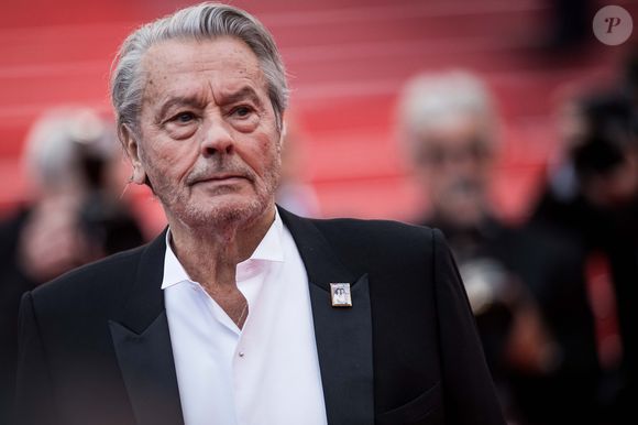 Entre sobriété et émotion, Douchy a rappelé combien Delon restait un voisin singulier et une figure toujours vivante dans la mémoire collective.

Alain Delon (avec un badge Paris Match d'une ancienne couverture du magazine titrant "Alain Delon, mes deux amours, Rosalie et Anouchka) - Montée des marches du film "A Hidden Life" lors du 72ème Festival International du Film de Cannes. Le 19 mai 2019
© Jacovides-Moreau / Bestimage