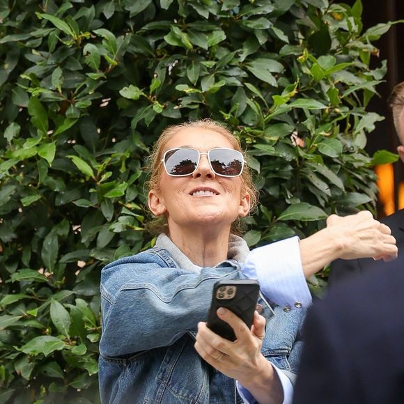 Paris, FRANCE - Celine Dion takes pictures and waves to fans as she prepares to perform for the Olympic Games in Paris, creating joyful memories with her admirers. Pictured: Céline Dion